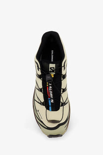 Salomon men’s technical fabric sneakers in cream with black accents feature a rugged breathable design for trail running