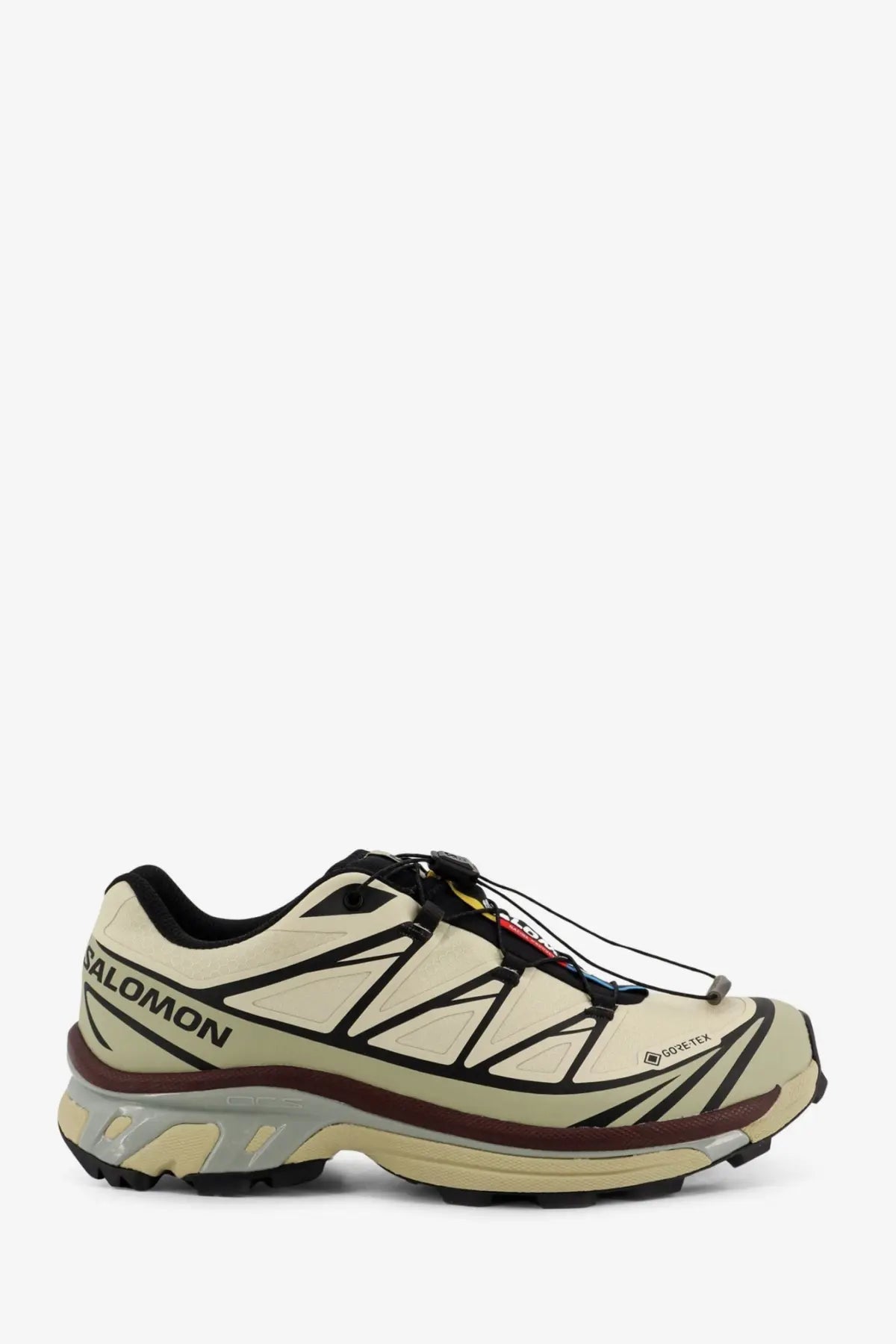 Salomon men’s technical fabric sneakers in cream with black and brown accents featuring breathable mesh and rugged tread