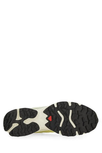 Salomon unisex sneaker in black and cream with a rugged outsole featuring white traction patterns for trail running