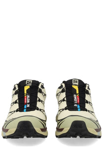 Cream-colored Salomon unisex sneaker XT white trail running shoes with black yellow and blue lace accents
