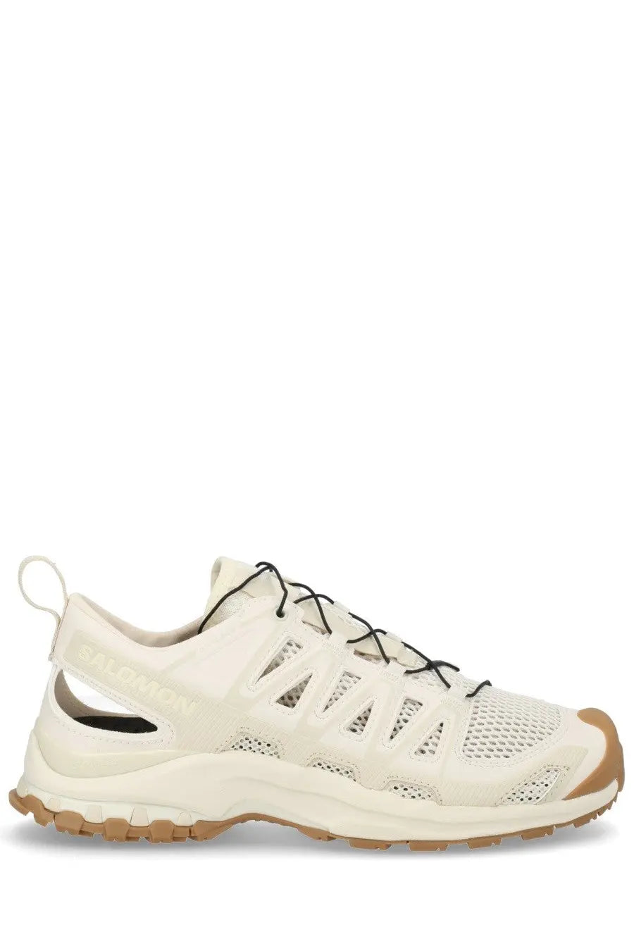 Cream-colored Salomon XA Pro 3D Amphib trail running shoe with black laces and tan rubber outsole for outdoor use