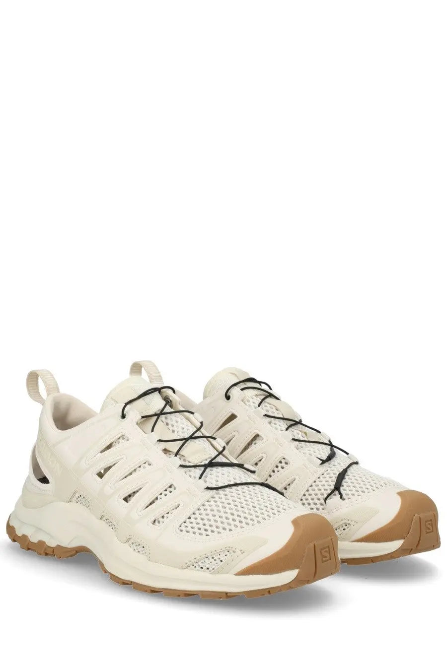 Cream-colored Salomon unisex XA Pro 3D Amphib sneaker with black laces and tan rubber soles for trail running