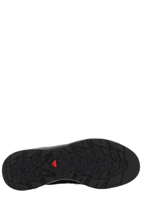 Black rubber sole with red triangular logo and textured tread on Salomon x Carhartt wip unisex sneaker