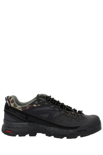 Black salomon x carhartt wip unisex hiking shoe with camouflage accents and rugged tread pattern in black