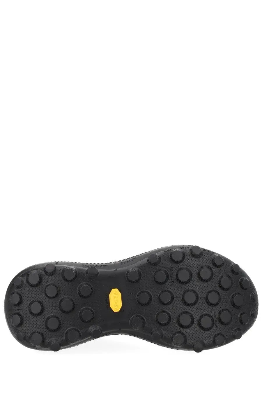 Black rubber sole of satisfy men’s sneaker therocker black with yellow vibram logo and circular traction lugs