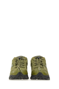 Olive green saucony men’s progrid triumph sneakers with black rubber soles and laces for running and casual wear