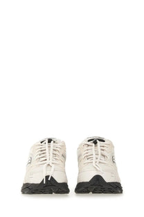 Saucony men’s Progrid Triumph sneaker in cream with textured upper black rubber soles and laces