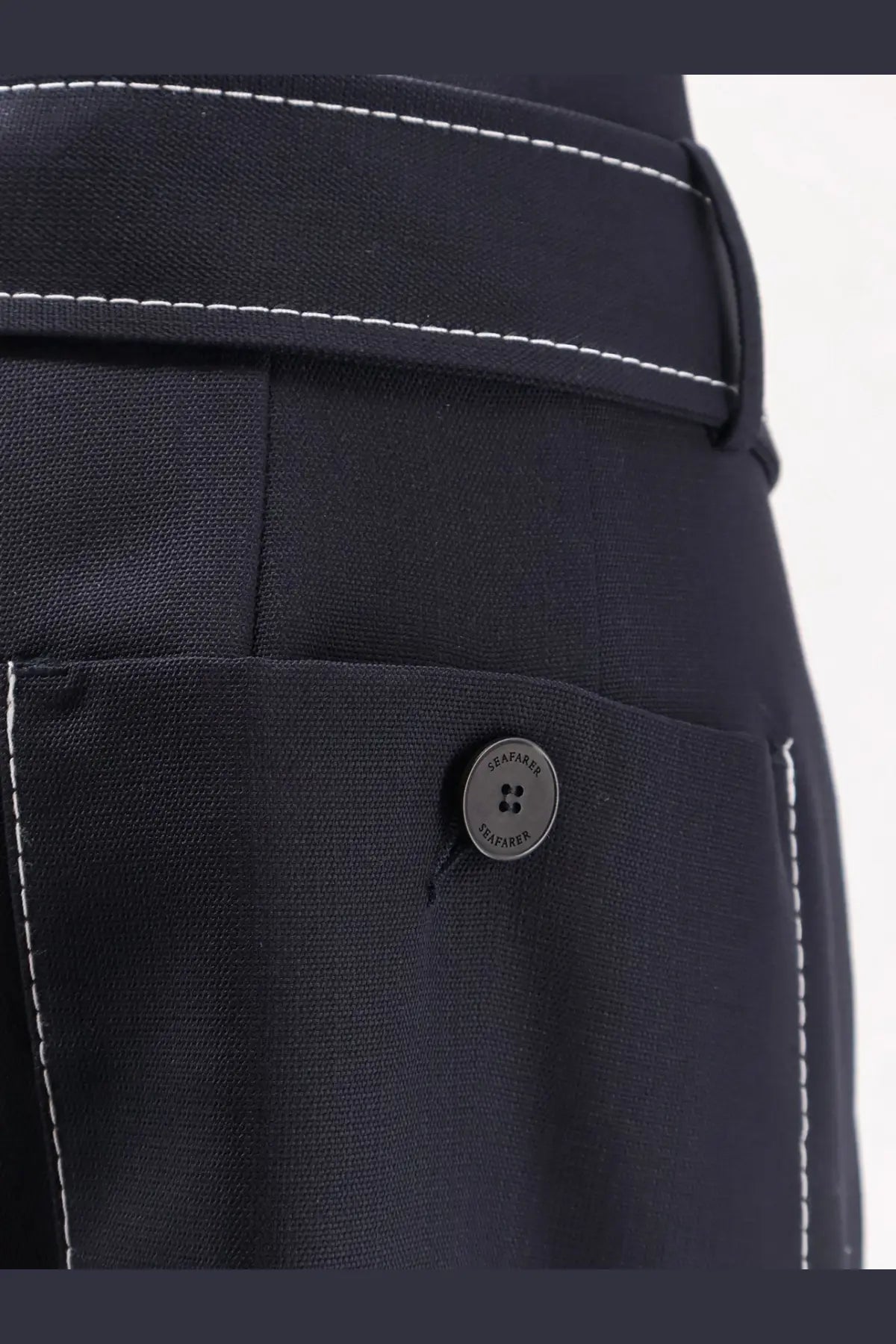 Dark navy seafarer women’s irony virgin wool trousers with contrasting white stitching and branded button