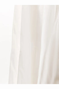 A soft flowing white cotton curtain with gentle vertical folds showcasing lightweight fabric texture