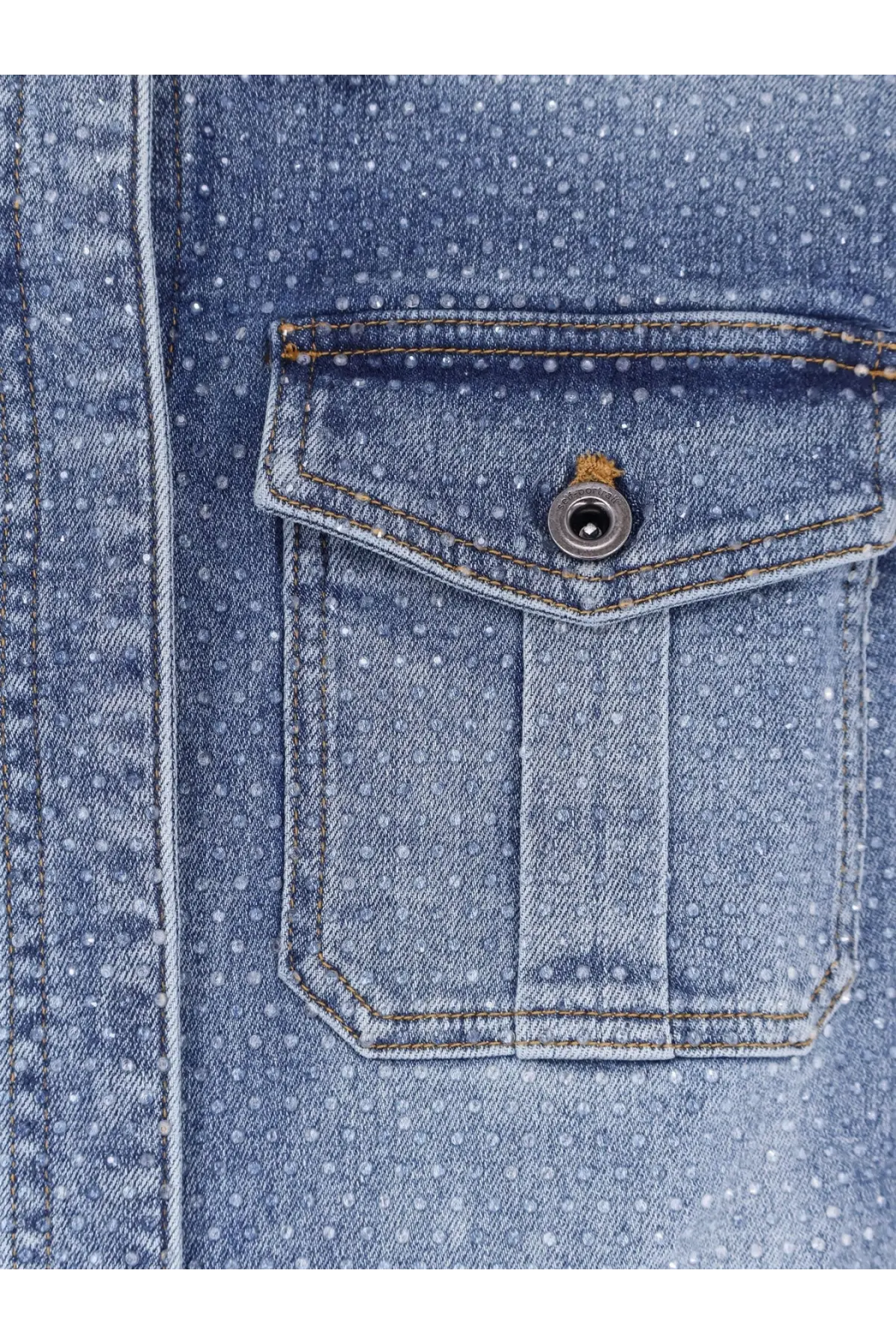 Blue denim shirt pocket with white polka dots and silver button on self portrait women’s denim jumpsuit blue