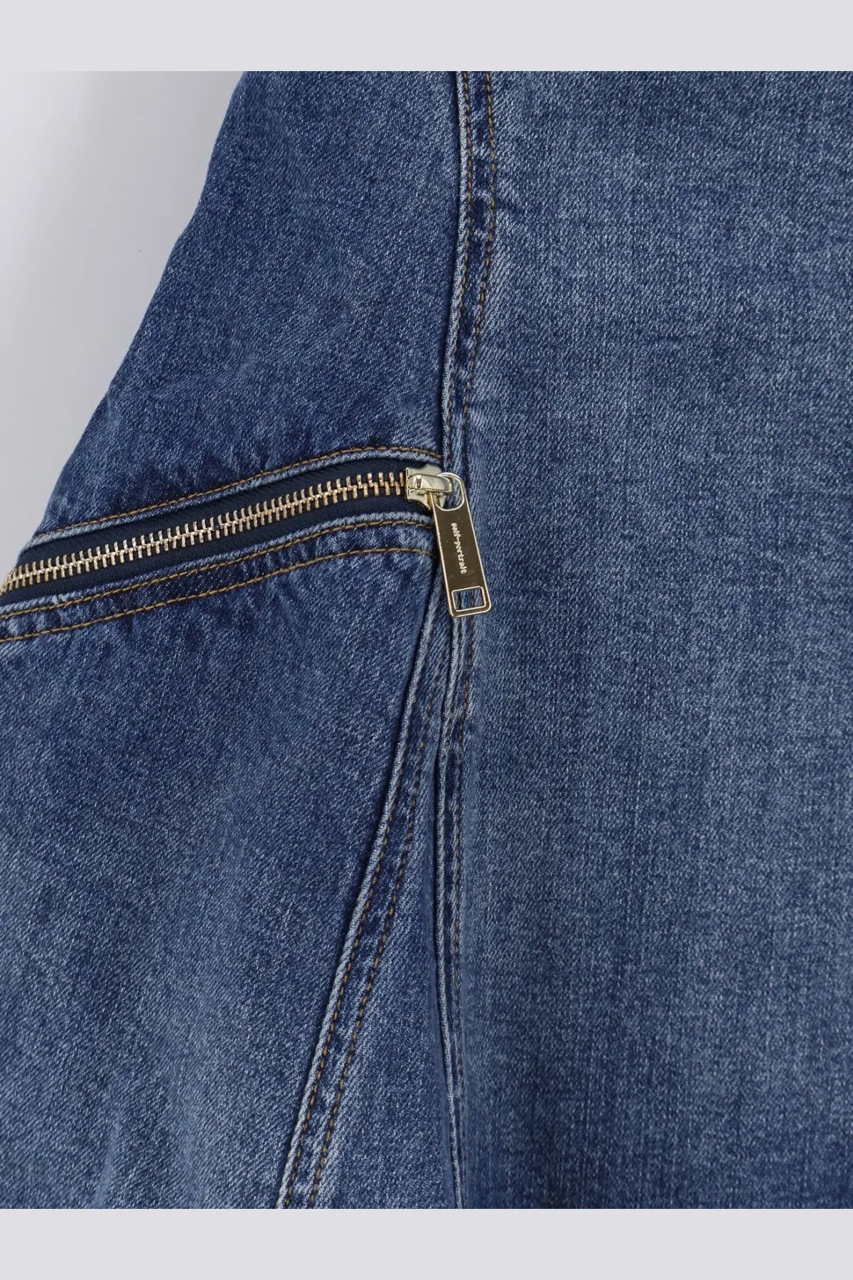 Blue denim jacket with gold-toned maison margiela zipper pull paired with self-portrait women’s flared denim mini dress