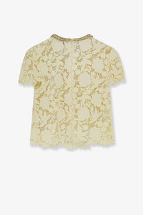 A delicate cream-colored lace short sleeve top with a decorative gold-trimmed neckline by Self-Portrait