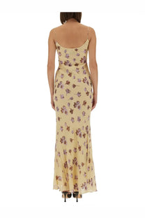 Self-portrait women’s long dress in flowing pale yellow with delicate floral pattern in muted purples and browns