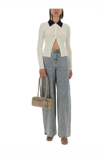 Beige structured handbag with top handles and decorative bow detail paired with self-portrait white merino wool cardigan
