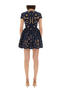 Navy blue lace mini dress with intricate floral patterns and short sleeves from self-portrait women’s collection