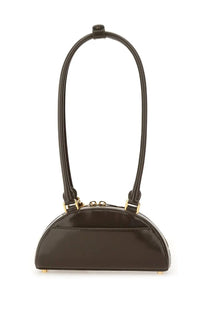 Black semi-circular mini shoulder bag with glossy finish gold-tone hardware and curved top handle by Self-Portrait