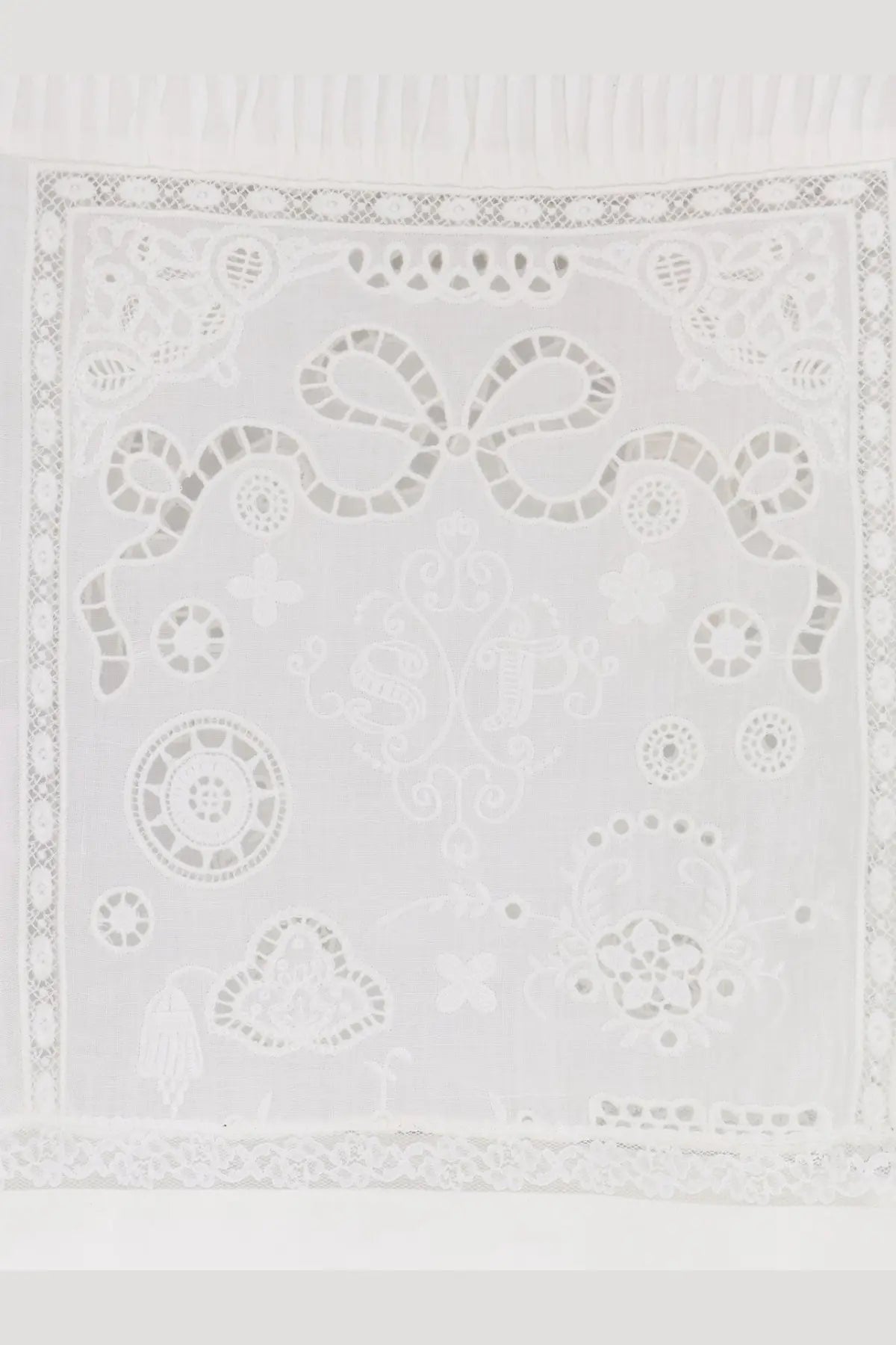 A delicate white embroidered ramie square scarf with intricate lace patterns and a central bow design for women