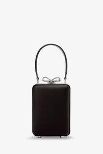 Black leather box clutch with silver bow clasp and curved handle for women by self-portrait