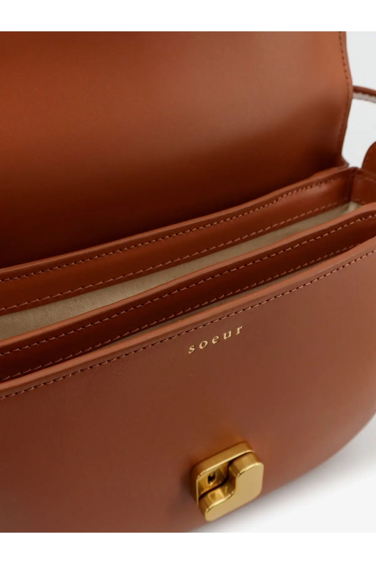 Tan leather soeur women’s bellissima mini crossbody bag with gold-tone clasp and embossed brand name on front
