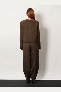 Brown tailored two-piece suit with structured shoulders made from virgin wool in a sleek minimalist design