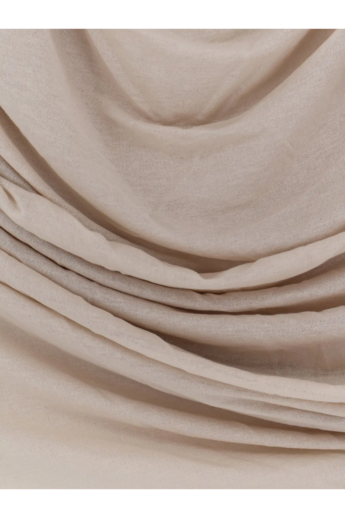 A soft flowing beige scarf made of lightweight extra fine cotton crepe in soeurs irina mastic collection
