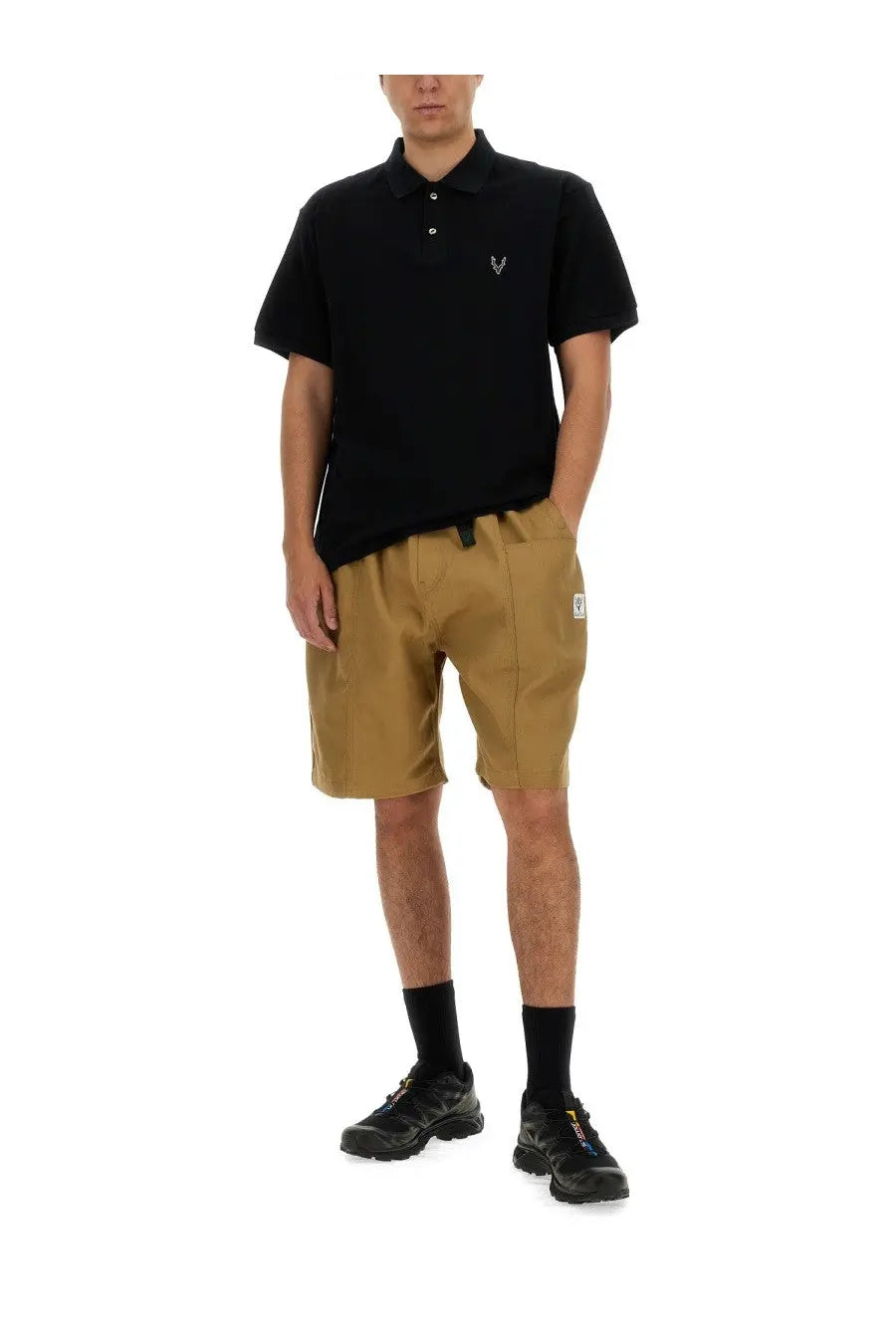 Black short-sleeved cotton polo shirt with small white embroidered logo on left chest for men