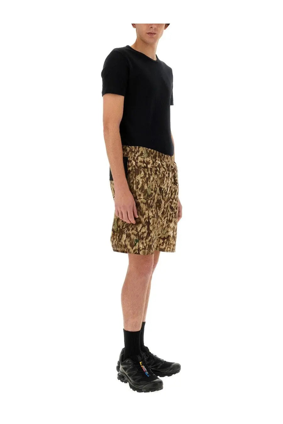 Black short-sleeved t-shirt with a simple crew neckline paired with South2 West8 men’s poly stretch bermuda shorts multicolor