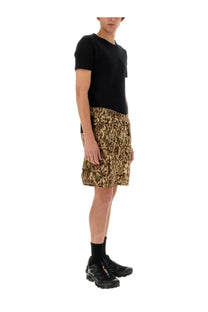 Black short-sleeved t-shirt with a simple crew neckline paired with South2 West8 men’s poly stretch bermuda shorts multicolor