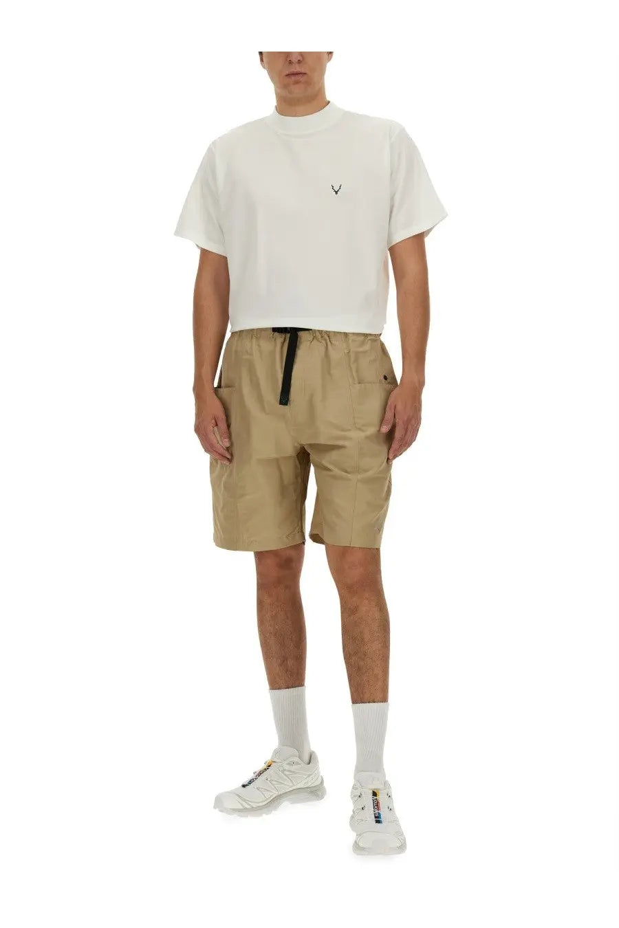 Beige cargo shorts with black drawstring waistband and multiple pockets paired with south2 west8 men’s white shirt