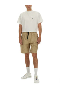 Beige cargo shorts with black drawstring waistband and multiple pockets paired with south2 west8 men’s white shirt