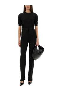 Black puffer handbag with sleek modern design and shiny black zipper details paired with Sportmax women’s Raoul black pants