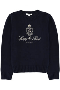 Navy blue ribbed knit sweater with white embroidered crest logo and sporty &amp; rich new york text in unisex jersey blue style