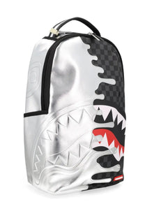 Sprayground unisex silver side drip backpack with silver and black checkered shark mouth design and red teeth accents