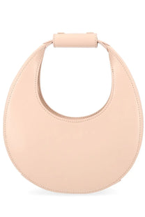 A sleek blush pink leather crescent mini handbag with a top handle from Staud women’s Borsa Moon collection