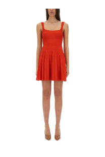 Staud women’s Ellison short dress in vibrant red ribbed knit with square neckline and pleated mini skirt