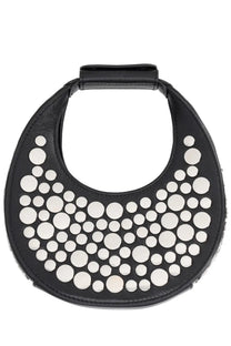 Staud women’s good night moon bag black is a circular black leather handbag with decorative white circular studs