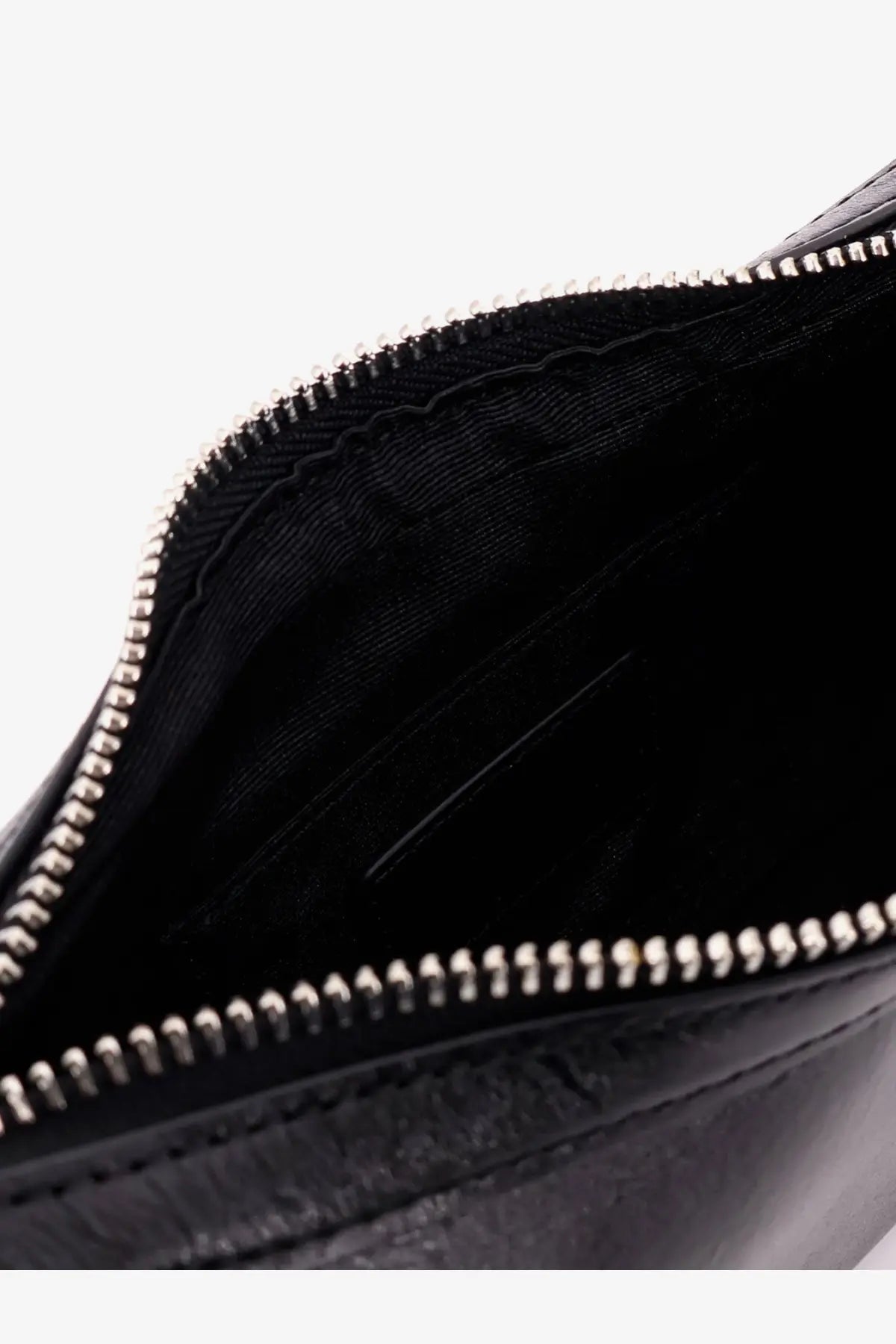 Black leather clutch with silver zipper and textured interior lining from Staud women’s leather shoulder bag black collection