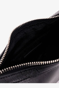 Black leather clutch with silver zipper and textured interior lining from Staud women’s leather shoulder bag black collection