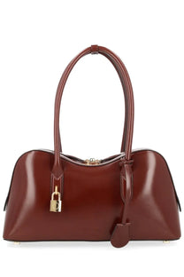 A sleek glossy burgundy leather stella mccartney borsa spalla ryder medium handbag with gold padlock closure