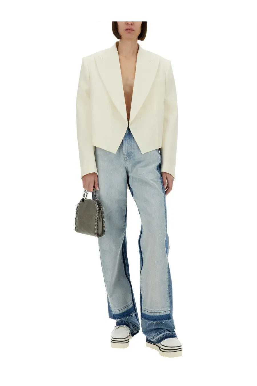 A sleek olive green textured handbag with silver-toned chain handles complementing a Stella McCartney white blazer