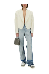 A sleek olive green textured handbag with silver-toned chain handles complementing a Stella McCartney white blazer