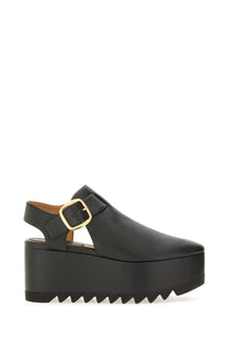 Stella McCartney women’s Elyse sandal black leather platform with gold-tone buckle and serrated sole front view