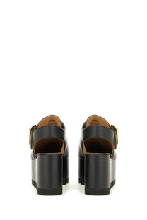 Stella McCartney women’s Elyse black platform sandals with gold-tone buckle details and vegan leather material