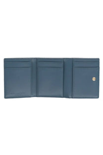 A sleek navy blue leather trifold wallet with precise stitching and gold-tone snap closure by Stella McCartney