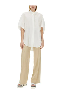 White oversized short-sleeved shirt with mandarin collar and button closure paired with stella mccartney beige flare fit pants