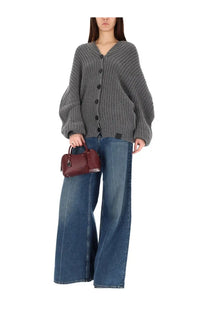 A burgundy leather handbag with a structured rounded shape and top handles shown with stella mccartney womens high waist jeans blue