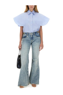 Light blue button-up blouse with wide flowing sleeves paired with stella mccartney women’s blue bootcut jeans