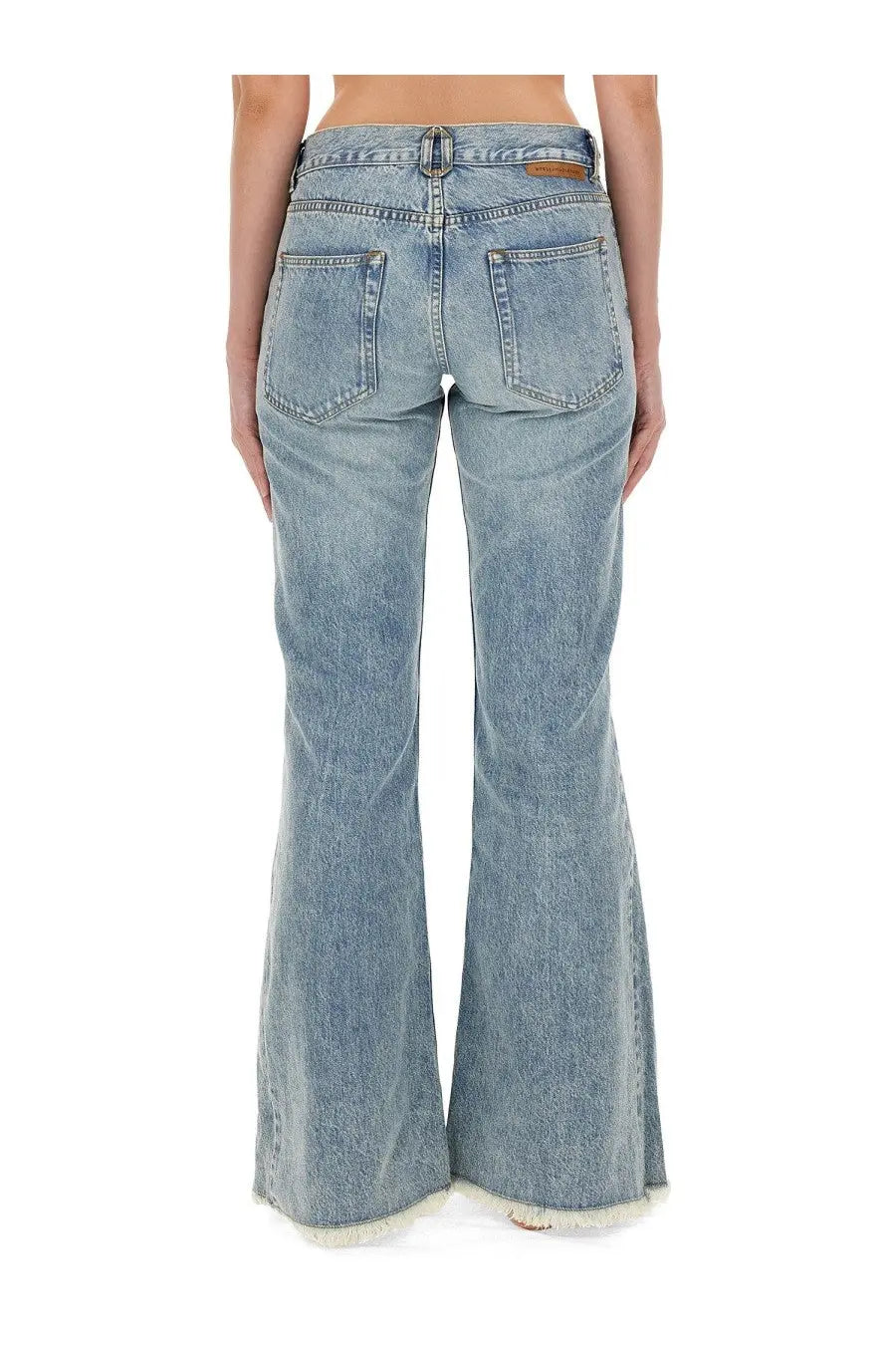 Back view of stella mccartney women’s light-wash denim bootcut jeans with frayed hem and classic pockets