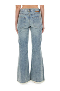 Back view of stella mccartney women’s light-wash denim bootcut jeans with frayed hem and classic pockets