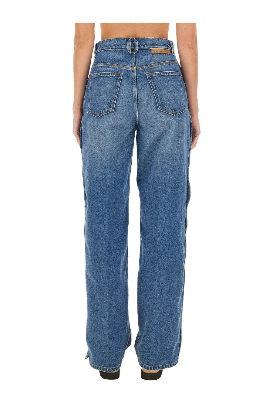 Back view of stella mccartney women’s blue high waisted wide leg denim jeans with classic pockets and subtle fading
